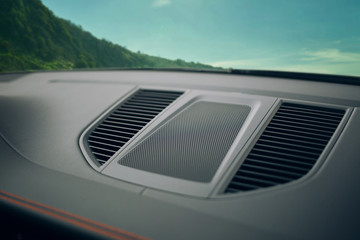 Sound speaker and air inlet in a modern car panel