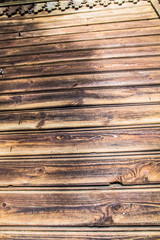 Wooden plank wall of a building in close up - background