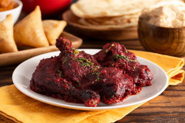 Dinner Set with Tandoori Chicken on a Wooden Table