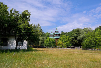  Old wooden orthodox church. Ukrainian church of the nineteenth century. Summer landscape, sunshine. Village Pirogovo.