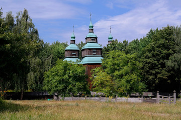  Old wooden orthodox church. Ukrainian church of the nineteenth century. Summer landscape, sunshine. Village Pirogovo.