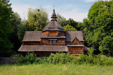 Old wooden orthodox church. Ukrainian church of the nineteenth century. Summer landscape, sunshine. Village Pirogovo.