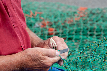 hands of a person repairing fishing tackles 