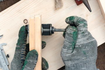 Carpenter is clamping a wooden billet in clamp.