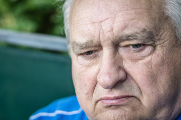 Brooding and angry old grandfather looking ahead