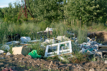 mountains of garbage lie along the road at the edge of the forest. Ecological catastrophy