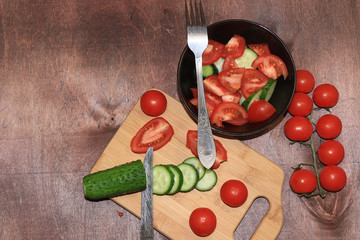 Tomatoes and cucumbers on a light wooden background, tasty and healthy food,