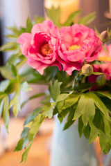Pink peonies in turquoise ceramic vase