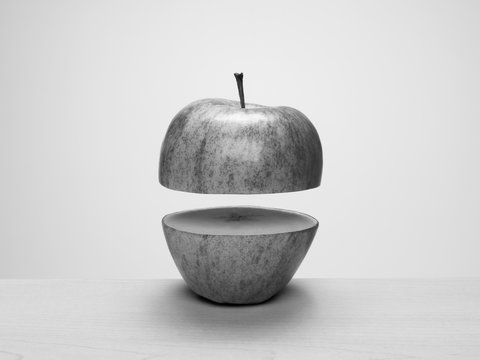 Apple cut in half with top floating above bottom