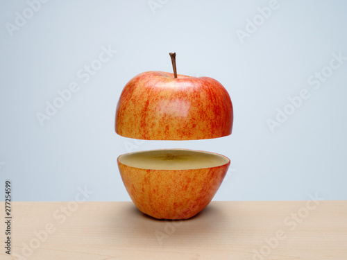 Fototapete Ripe Red Apple Cut In Half With Top Floating Above Bottom Mstock