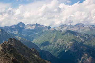 Fototapeta premium Mountains scene with dramatic cloudy sky in national park of Dombay