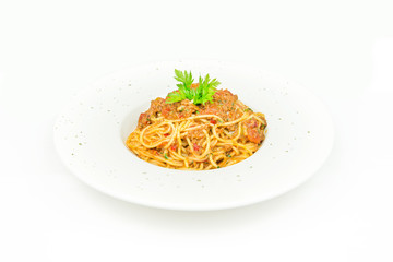 italian pasta bolognese with tomato sauce and basil on white plate