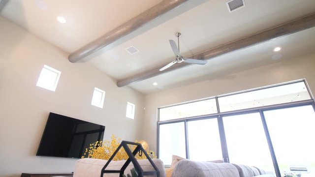 Wood Ceiling Beams Rise in Home. view moves up toward a wooden exposed ceiling beam design inside a home