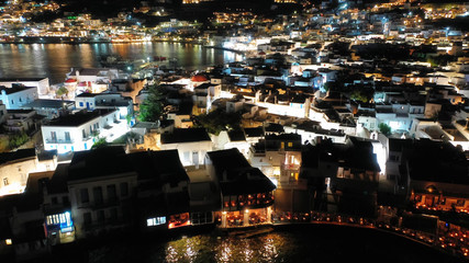 Aerial drone night shot from iconic illuminated main town of Mykonos island, Cyclades, Greece