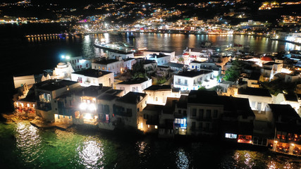 Aerial drone night shot from iconic illuminated main town of Mykonos island, Cyclades, Greece