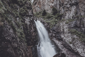 Closeup view of waterfall scenes in mountains, national park Dombay, Caucasus