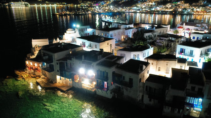 Fototapeta na wymiar Aerial drone night shot from iconic illuminated main town of Mykonos island, Cyclades, Greece