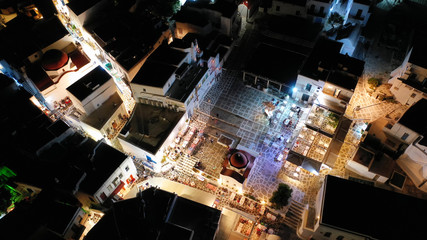 Aerial drone night shot from iconic illuminated main town of Mykonos island, Cyclades, Greece