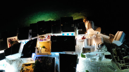 Aerial drone night shot from iconic illuminated main town of Mykonos island, Cyclades, Greece