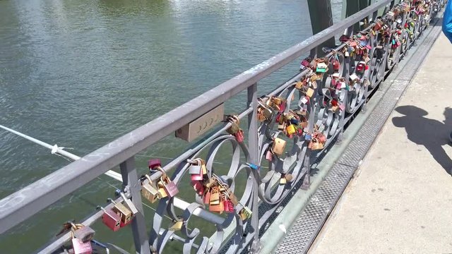 View of colorful locks of love on the Eiserner Steg (Iron Bridge) over the Main river in Frankfurt, July 2019