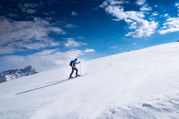 Ski tourer in the alps ascending