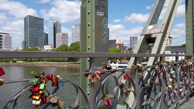 View of colorful locks of love on the Eiserner Steg (Iron Bridge) over the Main river in Frankfurt, July 2019