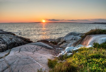 sunset and rocky coastline Peggys Cove Nova Scotia Canada