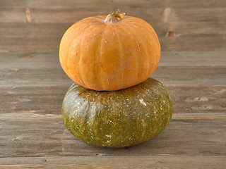 Beautiful juicy pumpkins .In the background with pumpkin seeds.On a dark and light background.On a wooden background.