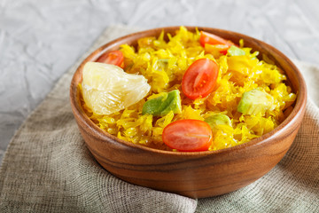Fried pomelo with tomatoes and avocado in wooden plate on gray concrete background. side view, close up.