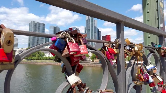 View of colorful locks of love on the Eiserner Steg (Iron Bridge) over the Main river in Frankfurt, July 2019