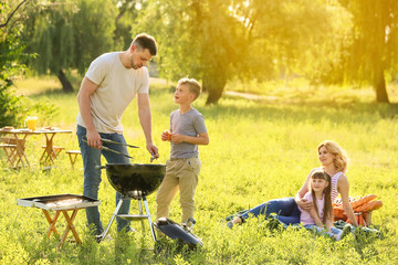 Happy family on summer picnic in park