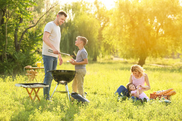 Happy family on summer picnic in park