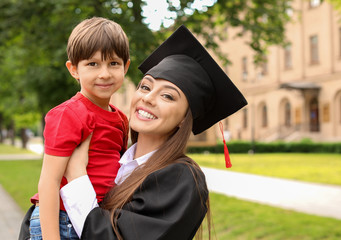 Woman with little son on her graduation day