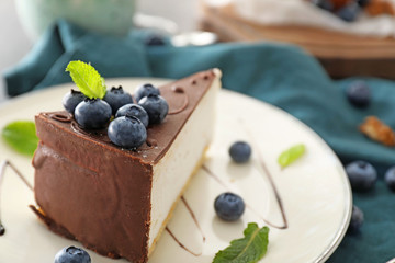 Plate with tasty cake and blueberry on table, closeup