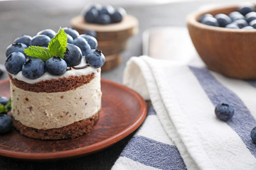 Tasty blueberry cake on table
