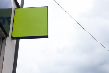 Green ad board on the street with copy space for advertisement.