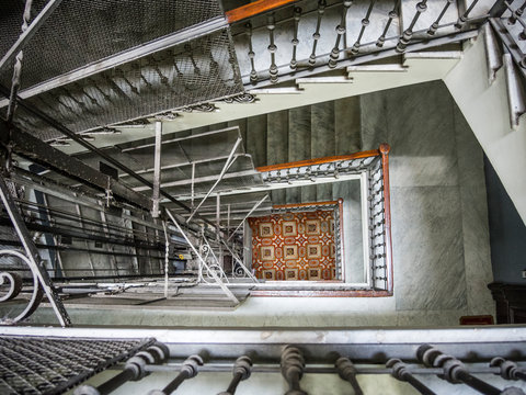 View Down European Apartment Building Elevator Shaft To Lobby Tile Floor 