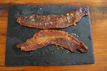 Two Slices of Country Bacon on a Slate Plate