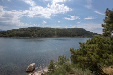 Bay near the sea and blue cloudy sky.