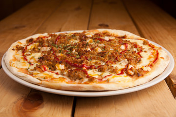 Delicious Barbecue pizza on a wooden table.