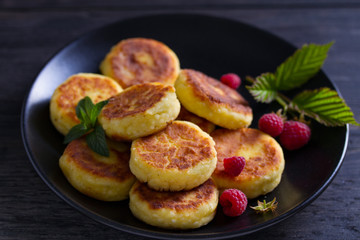 Cottage cheese pancakes. Syrniki and raspberries