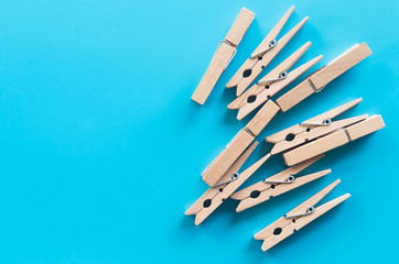 wooden clothespins on blue background