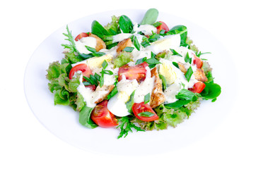 White plate with vegetable salad with egg and mayonnaise, isolated.