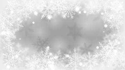 Christmas blurred background with frame of complex defocused big and small snowflakes in white and gray colors with bokeh effect