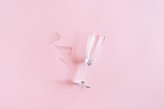 Broken Champagne Flute With Splinters On Pink Background With Copy Space. Concept Fight Against Alcoholism, Drunkenness And Refusal Of Alcohol. Creative Top View Flat Lay