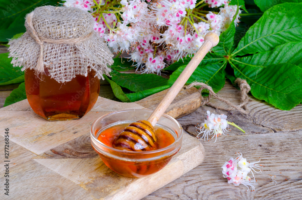 Sticker Fragrant chestnut honey in jar with blossom flowers. 