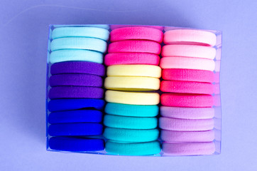 Colored hair ties on bright background. Photo