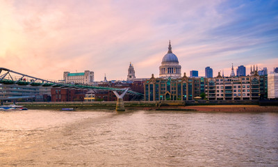 Naklejka premium St. Paul's Cathedral across Millennium Bridge and the River Thames in London, UK.