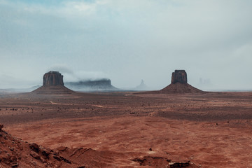 Fototapeta na wymiar the mountains of monument valley under the snow and in the fog. 
