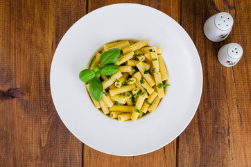 Penne pasta with pesto sauce. Italian cuisine. 